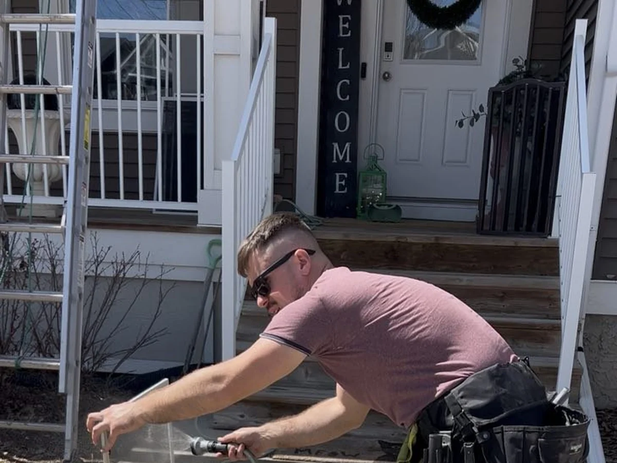 Crystal Touch technician cleaning residential glass